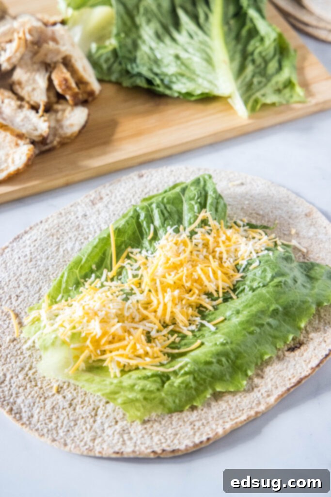 This easy Chick Fil A Cool Wrap recipe is the best excuse to skip the drive-thru! Enjoy this copycat at home with your favorite dipping sauce. A tortilla wrap topped with a lettuce leaf and shredded cheese.