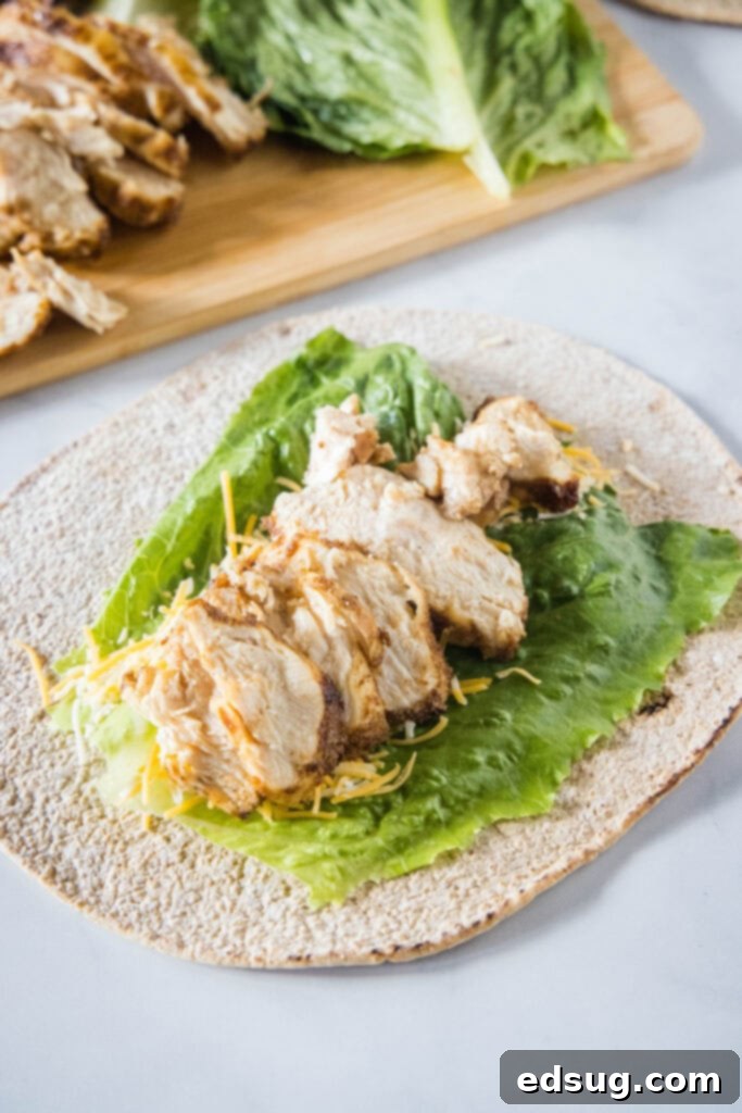 This easy Chick Fil A Cool Wrap recipe is the best excuse to skip the drive-thru! Enjoy this copycat at home with your favorite dipping sauce. A tortilla wrap topped with a lettuce leaf, shredded cheese, and shredded chicken.