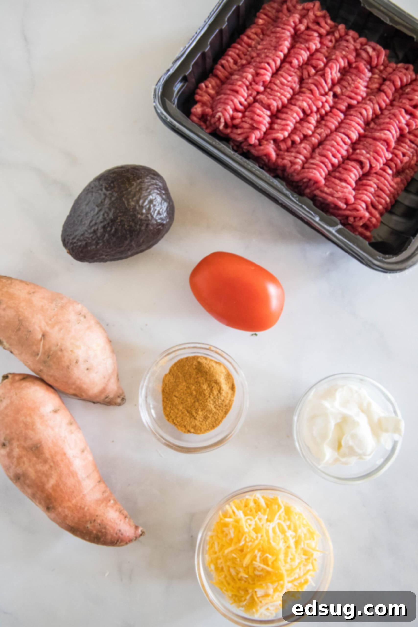 These taco stuffed sweet potatoes are soft and fluffy sweet potatoes piled high with savory ground beef and your favorite taco toppings! Ingredients for taco sweet potatoes.