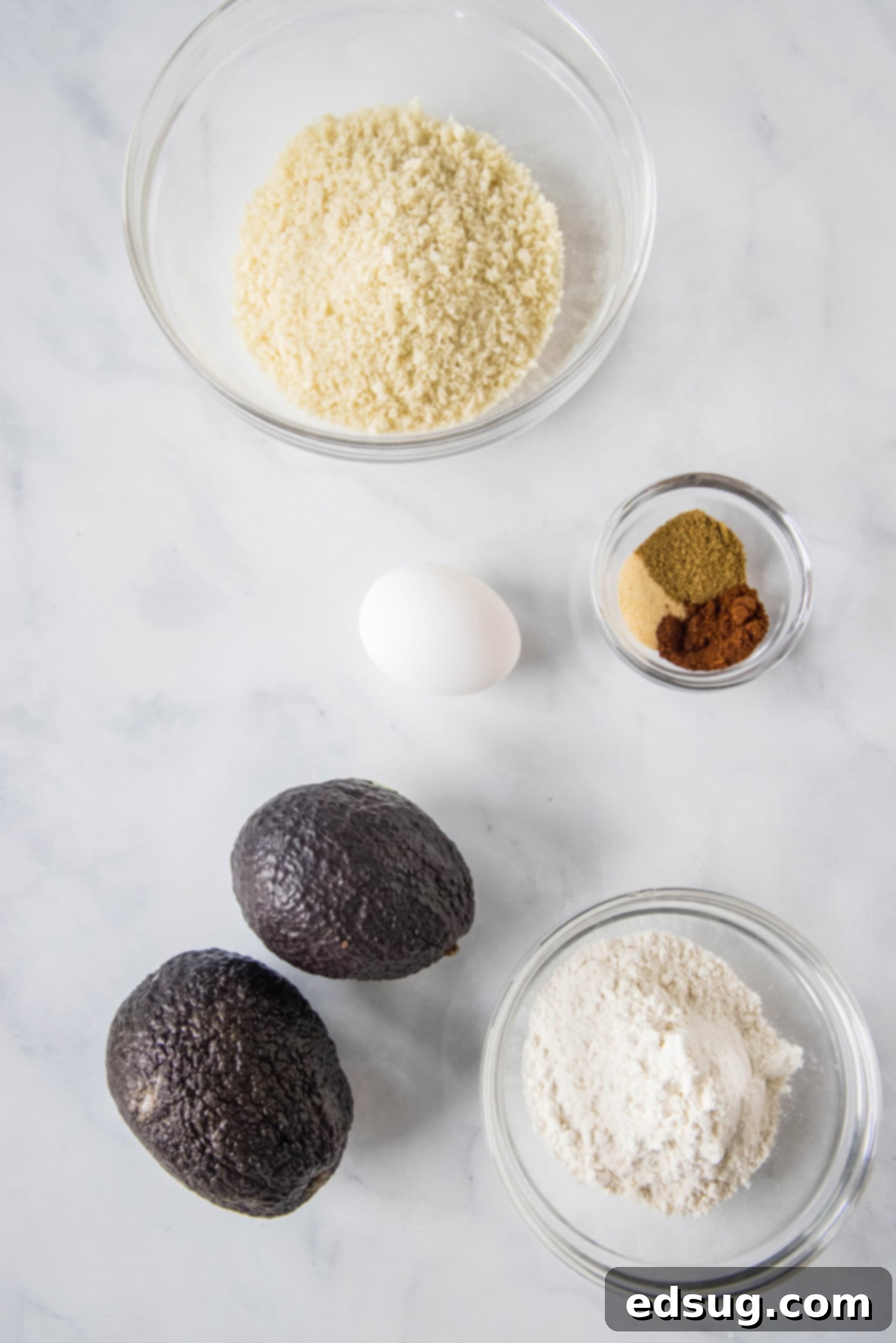 Avocado fries are crispy on the outside and warm and creamy on the inside, made in the air fryer (or oven). Don't forget the dipping sauce! Ingredients for homemade crispy avocado fries laid out on a clean surface.