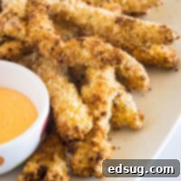Crispy Chicken Sticks 2 Chicken fries on an oval platter next to a bowl of dipping sauce.