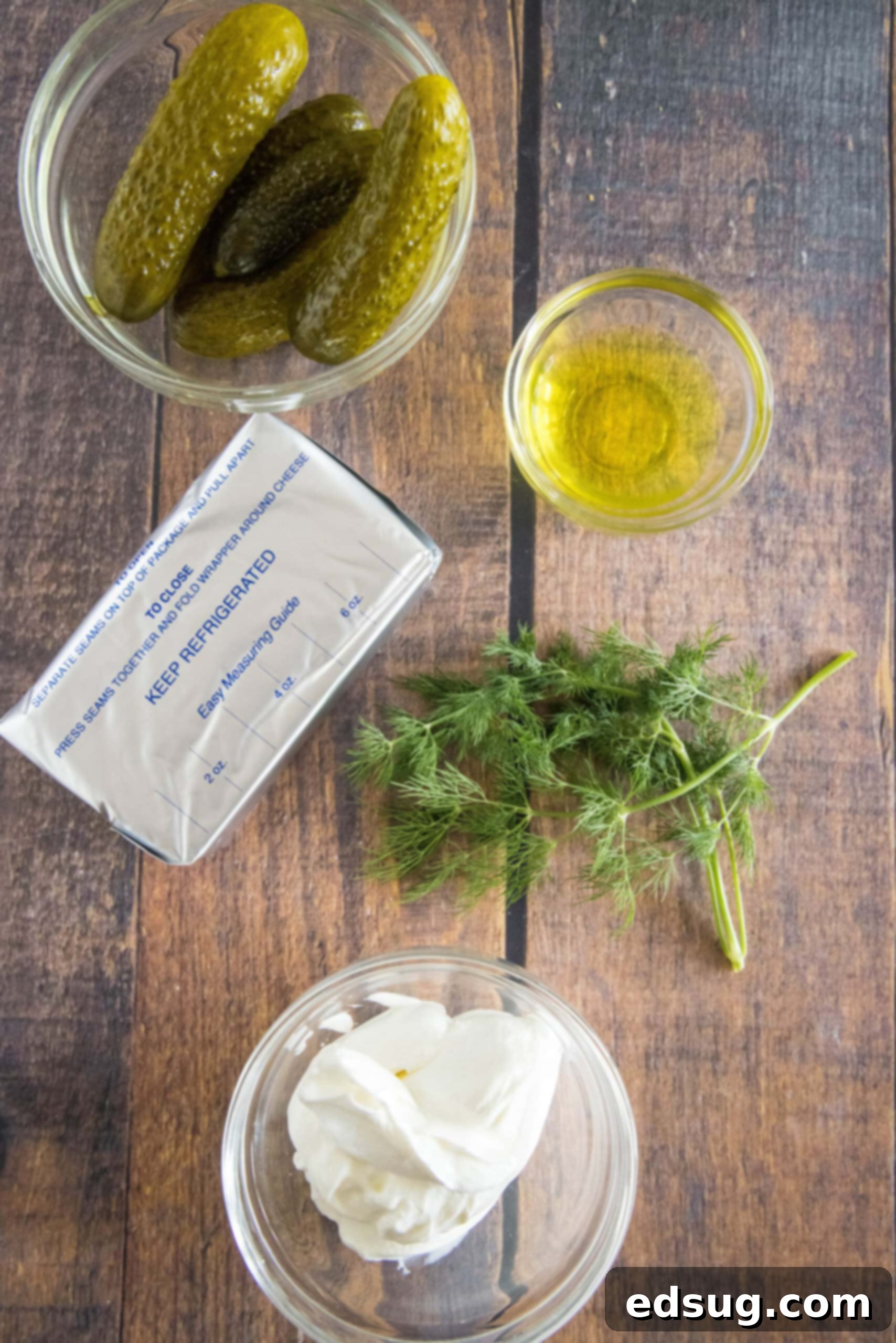 Creamy dill pickle dip is briny, cool, and crunchy. Made with 5 ingredients in minutes, it's delicious for dipping just about everything! Essential ingredients laid out for making creamy dill pickle dip.