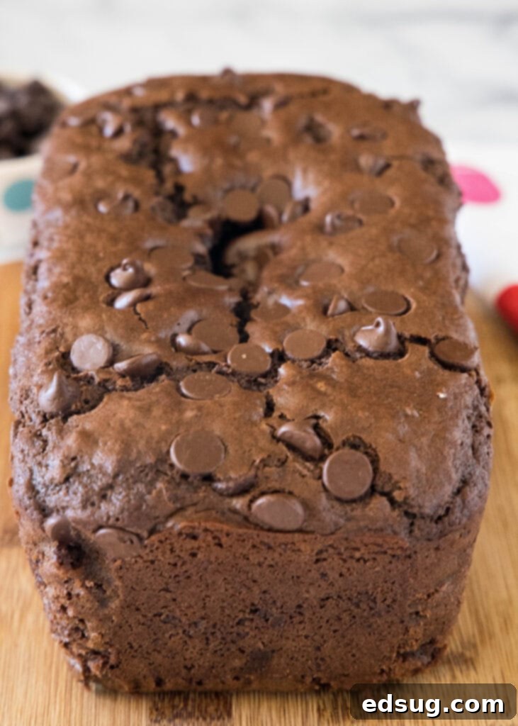 Baked chocolate bread on a wooden cutting board.