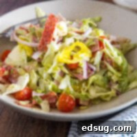 Grinder salad in a large white bowl, garnished and ready to eat.