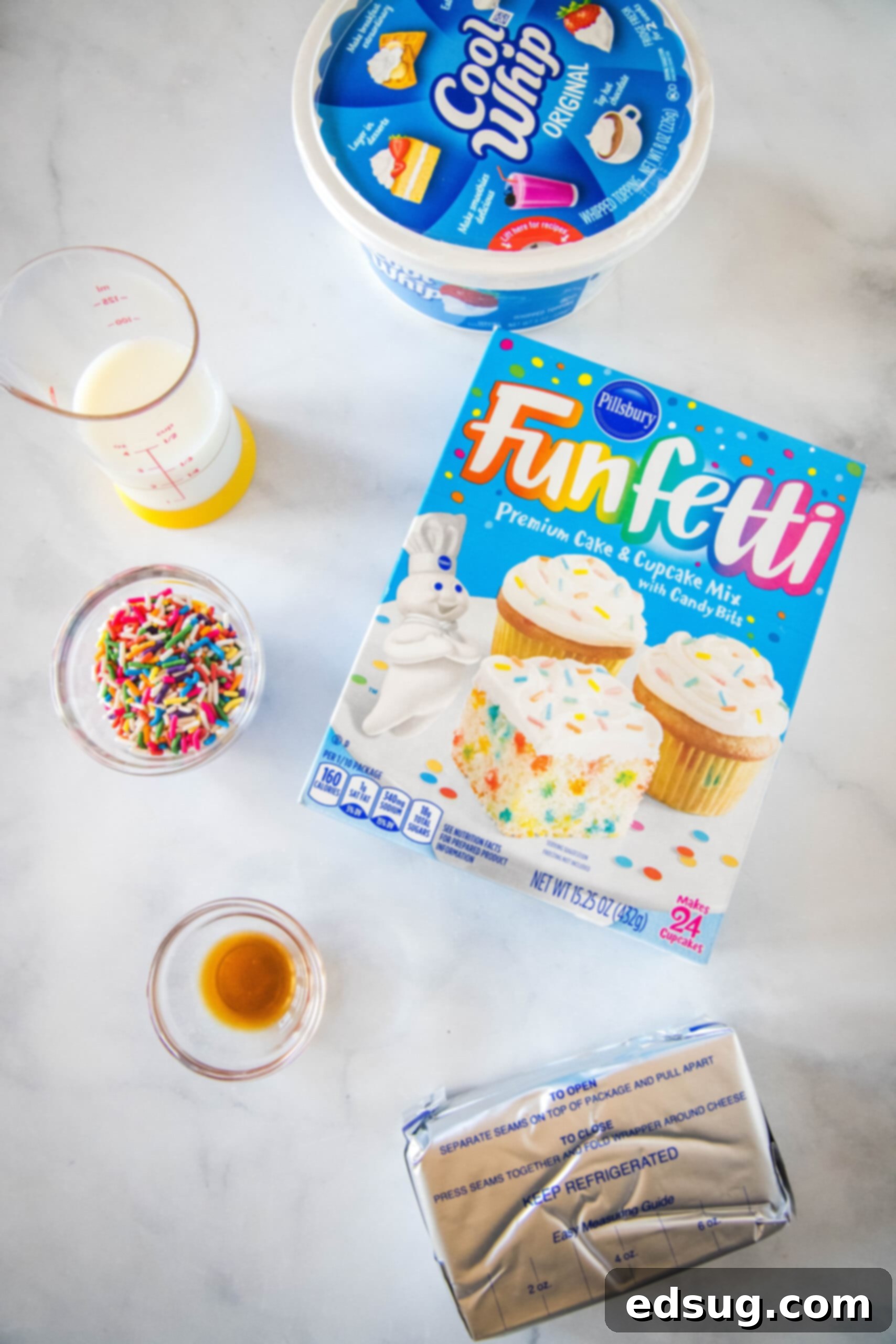 Ingredients for funfetti cake batter dip laid out on a wooden surface. Ingredients for funfetti cake batter dip laid out on a wooden surface.
