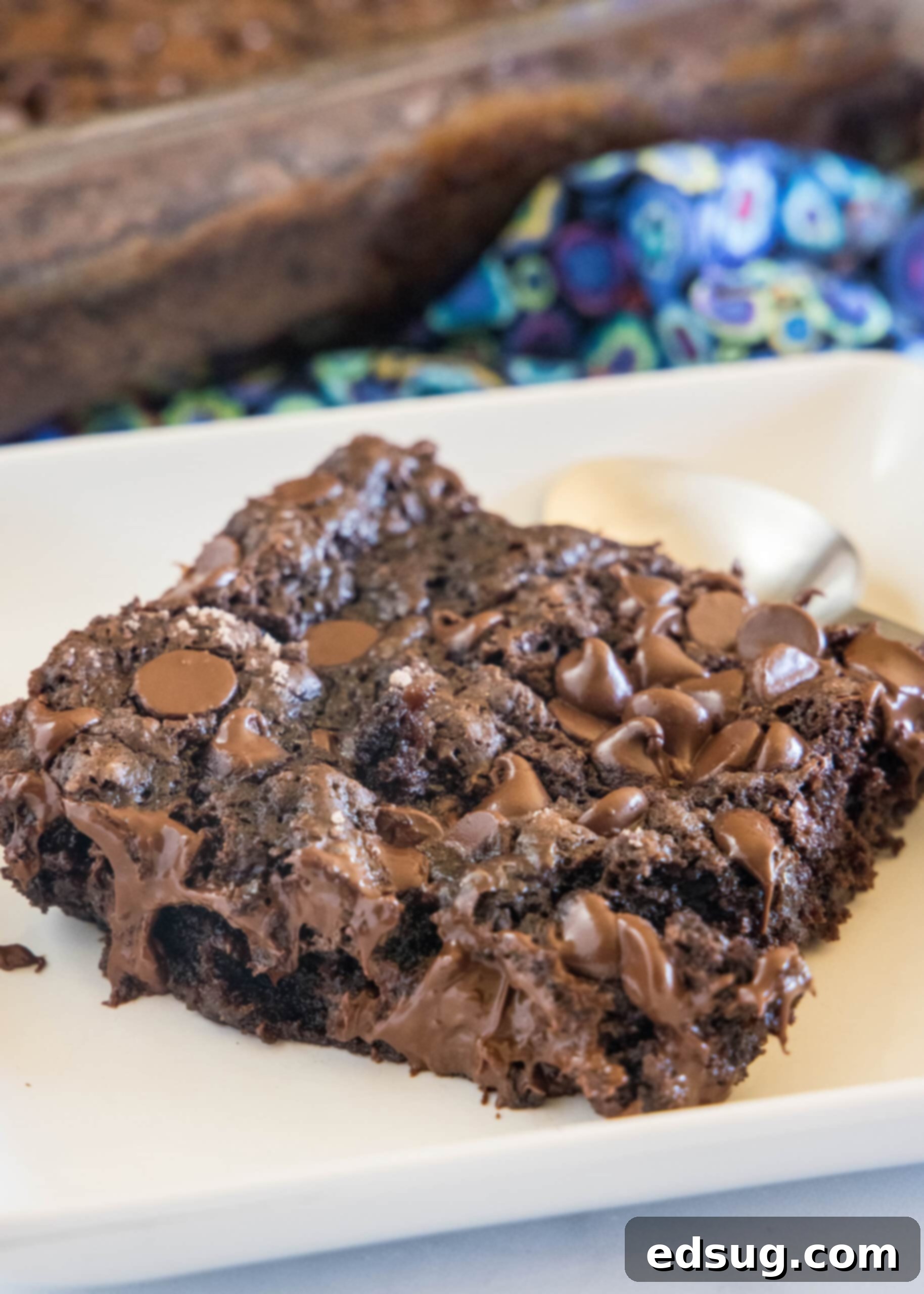 A slice of chocolate dump cake on a white plate.