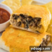 Crispy Grilled Cheese Burrito 2 Two halves of a grilled cheese burrito stacked on a plate next to salsa in a ramekin.