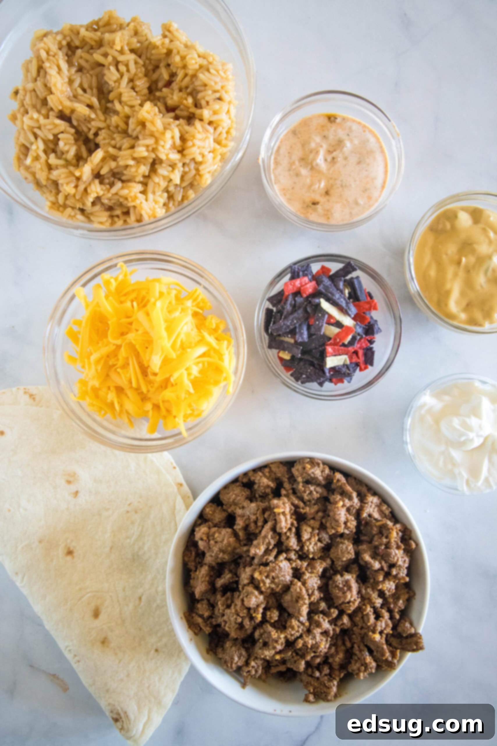 This copycat grilled cheese burrito recipe lets you remake an ooey-gooey Taco Bell favorite at home. Right down to the creamy chipotle sauce! Ingredients for a grilled cheese burrito.