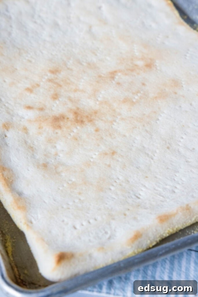 This satisfying breakfast pizza combines all of your breakfast favorites on top of a crispy pizza crust. It's so easy, baked in a sheet pan! Par-baked pizza crust prepared in a sheet pan, lightly golden.