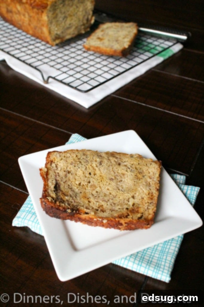 Whole Grain Banana Bread A delectable slice of Whole Grain Banana Bread, perfectly baked and enticing, next to the full loaf