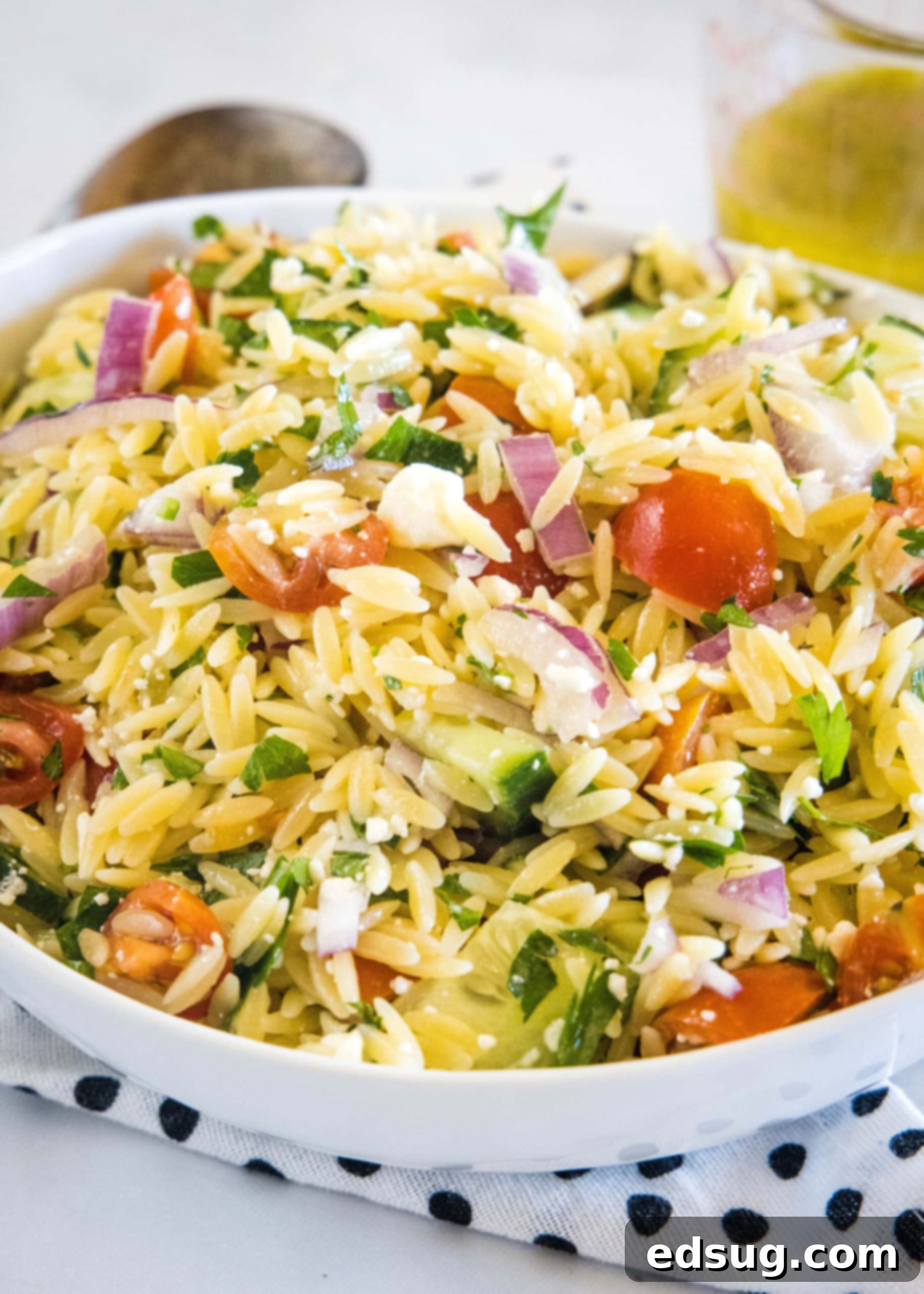 This orzo pasta salad is an easy summer side dish with tender orzo, crunchy cucumber, tomatoes, and feta tossed in a zesty lemon vinaigrette. Orzo pasta salad in a large bowl, ready to be served as a refreshing summer side.
