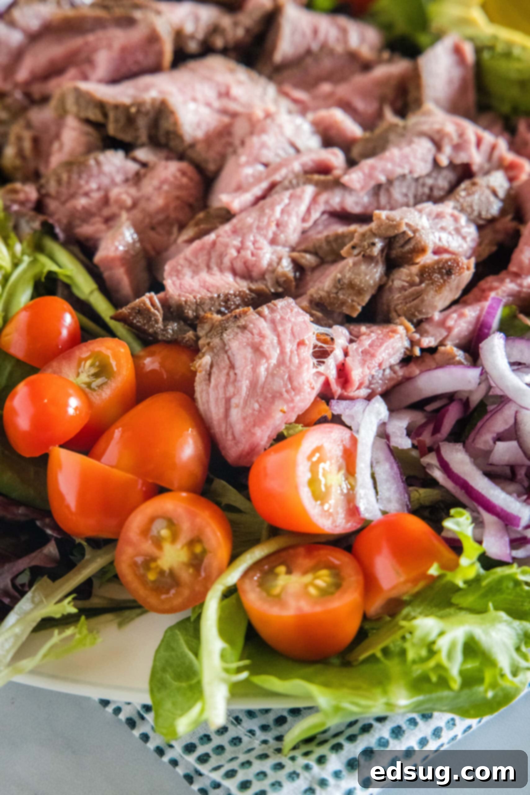 Close up of steak salad on a large platter.