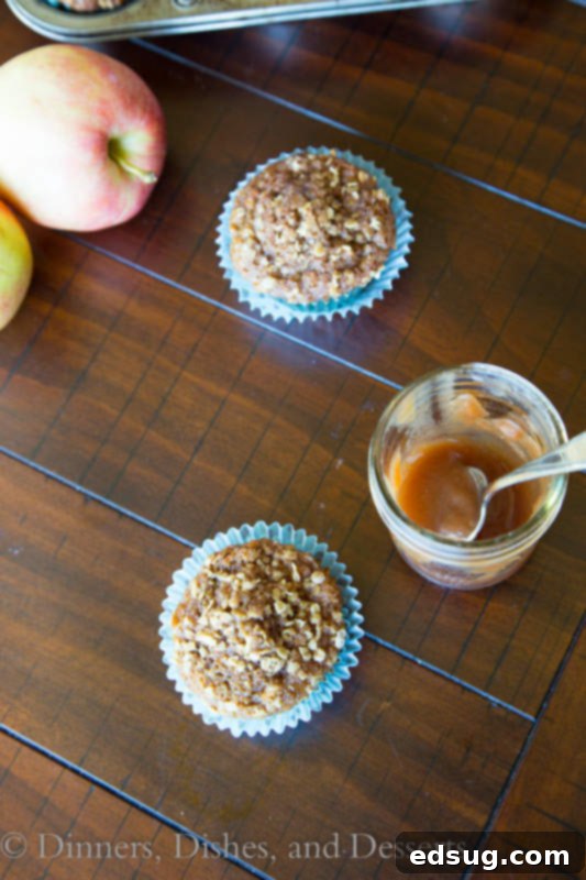 A stack of whole wheat apple butter muffins showcasing their golden crust and crumb topping.