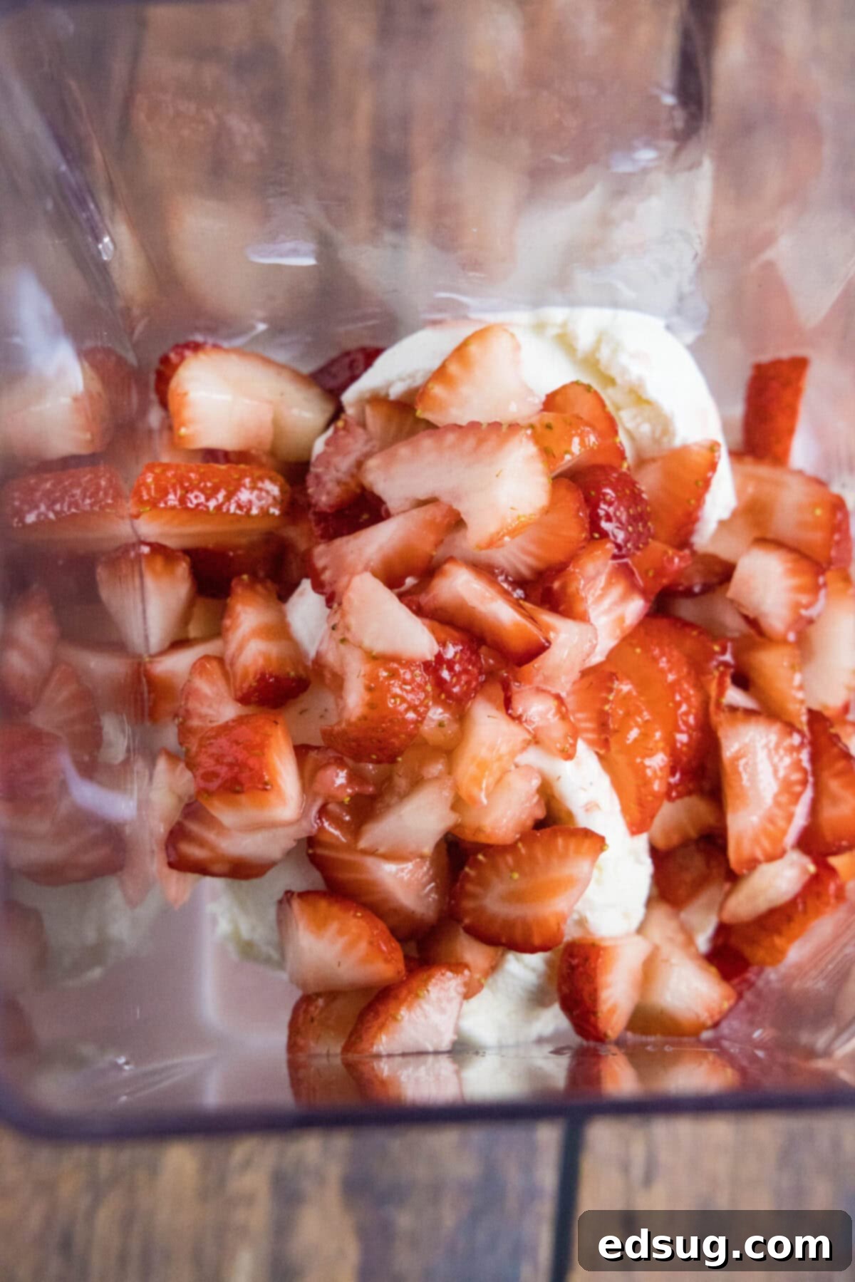 These 5-ingredient strawberry milkshakes are full of nostalgia and flavor. They're quick and easy to make, and absolutely delicious. Overhead view of a blender filled with ice cream, milk, and strawberries