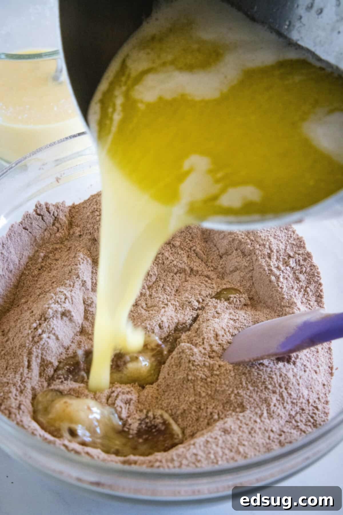 Irresistible Texas Sheet Cake 5 Melted butter and water being added to a bowl of dry ingredients for Texas Sheet Cake.