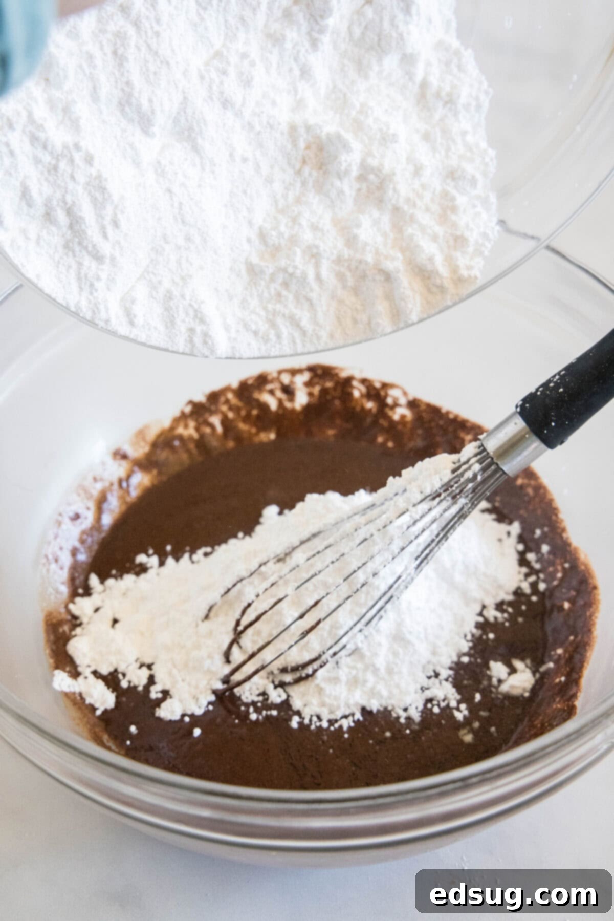 Irresistible Texas Sheet Cake 9 Adding powdered sugar to the warm chocolate mixture to create the frosting for Texas Sheet Cake.