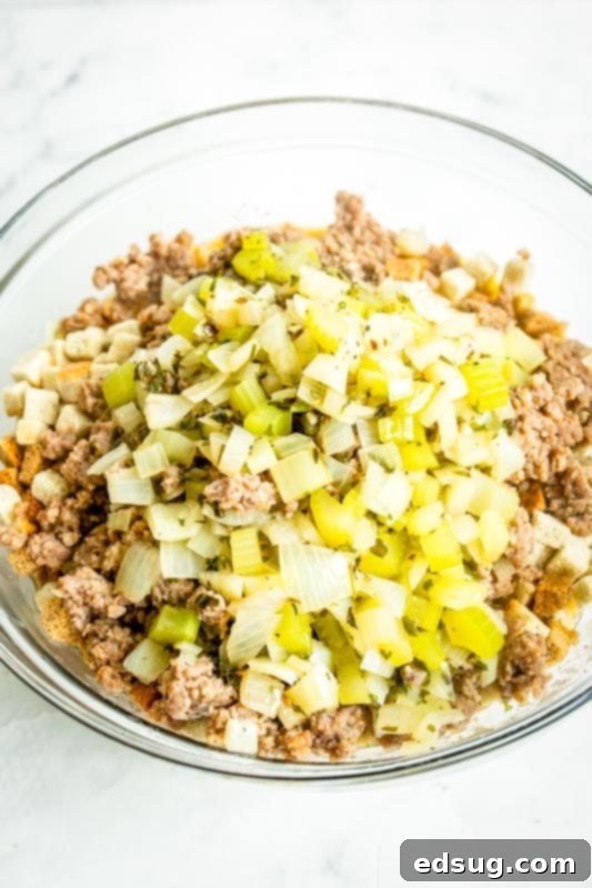 Savory Sausage Mix 5 Chopped celery, onions, and browned sausage in a large mixing bowl, ready for the next step of the stuffing recipe.