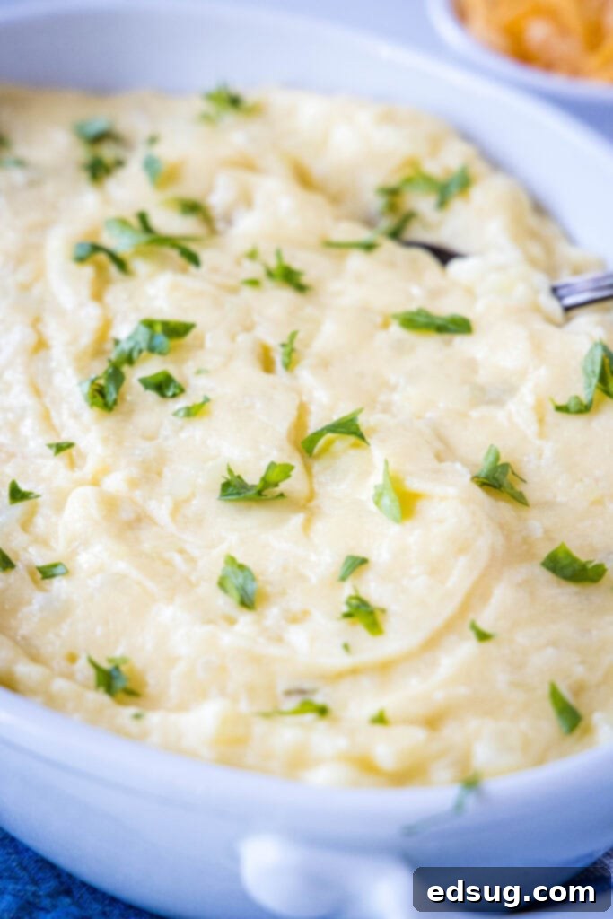 Ultimate Cheesy Mashed Potatoes 5 a baking dish with cheddar mashed potatoes