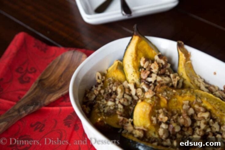 close-up of roasted acorn squash slices with rosemary and walnuts in a serving bowl