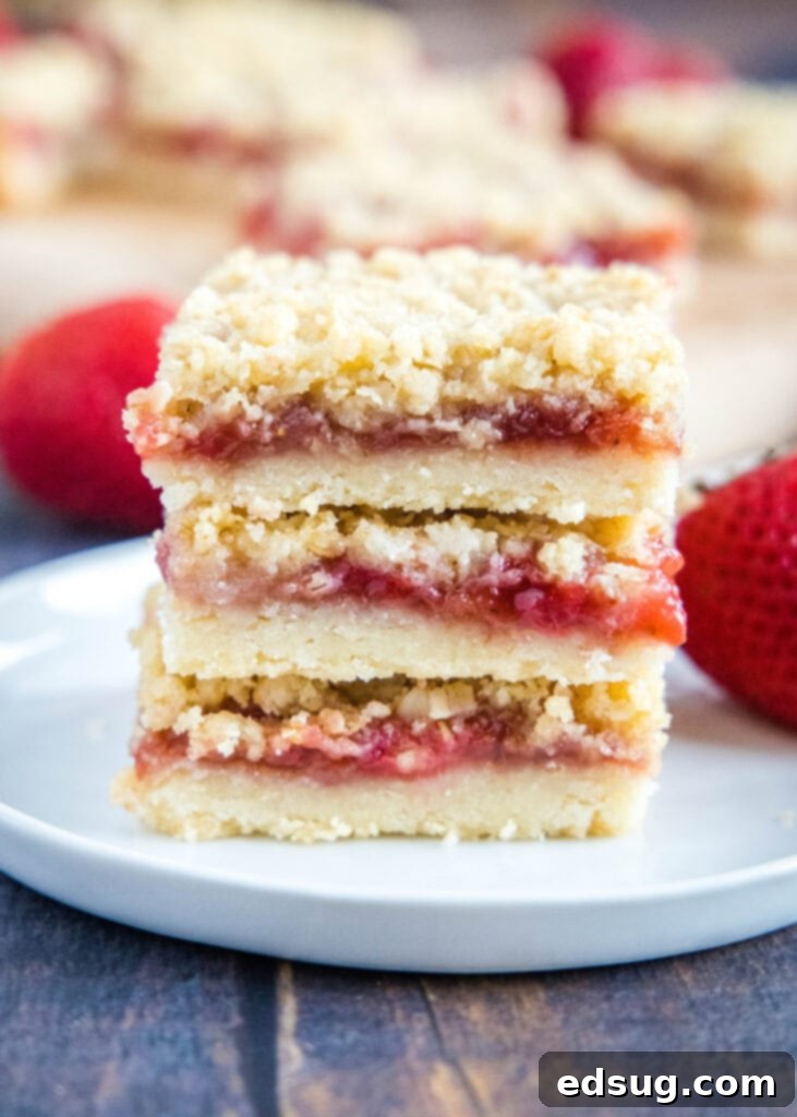 stacked strawberry streusel bars on a plate