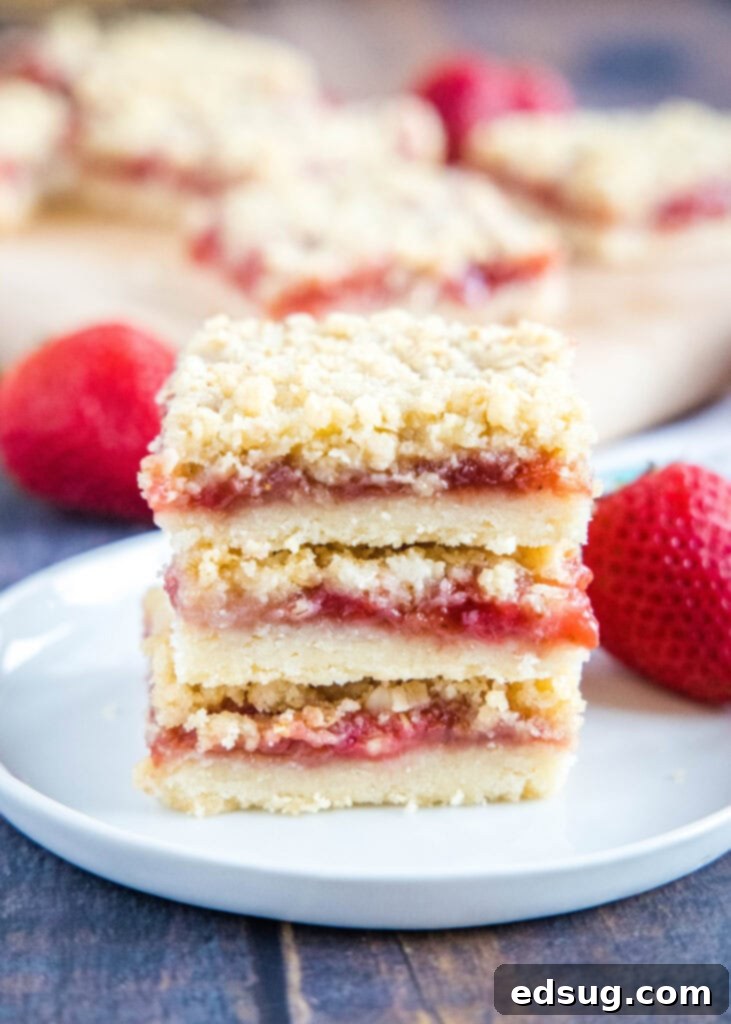 stacked strawberry bars on a plate, ready to be served