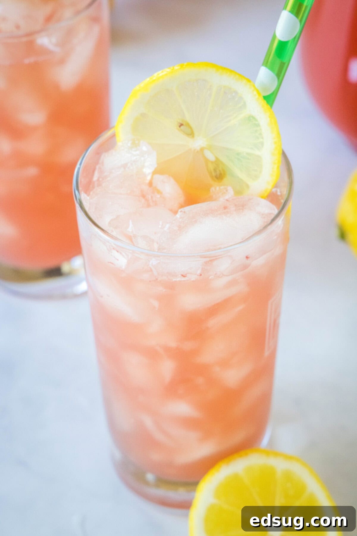 Sunny Watermelon Lemonade 5 A top-down view of a glass of watermelon lemonade with lemon slices and mint sprigs.