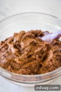 Decadent Chocolate Peanut Butter Truffle Cookies 8 Chocolate cookie dough in a bowl, covered with plastic wrap