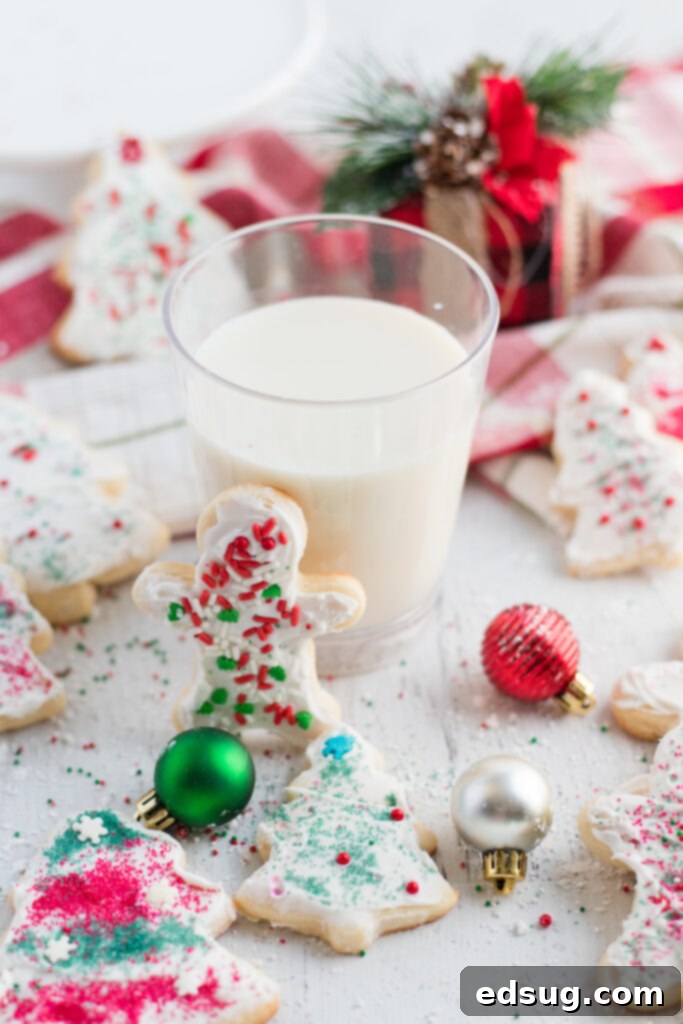Sugar Cookie Delights 6 A festive arrangement of frosted sugar cookies with sprinkles around a glass of milk, inviting and delicious.