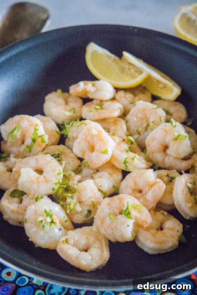 Zesty Garlic Butter Shrimp 4 shrimp in garlic butter in a skillet