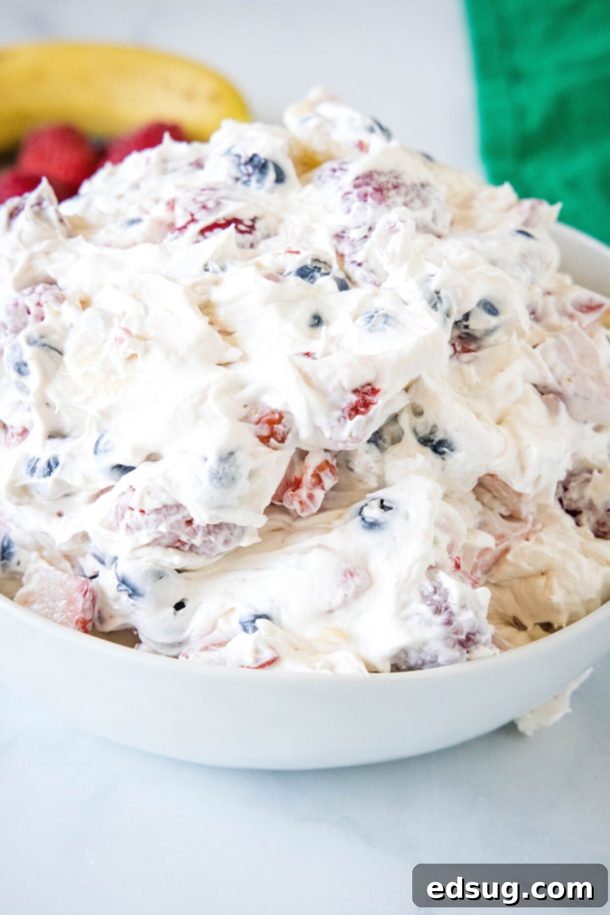 Cheesecake fruit salad in a bowl.
