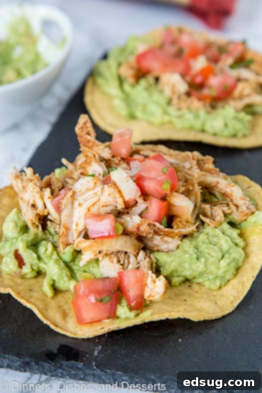 chicken tostada with guacamole on a plate