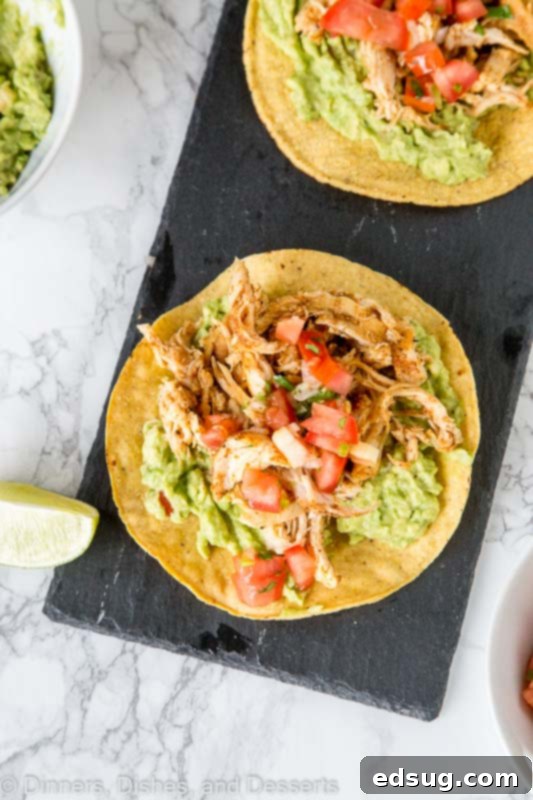 chicken tostada with guacamole on a plate
