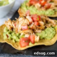 chicken tostada with guacamole on a plate