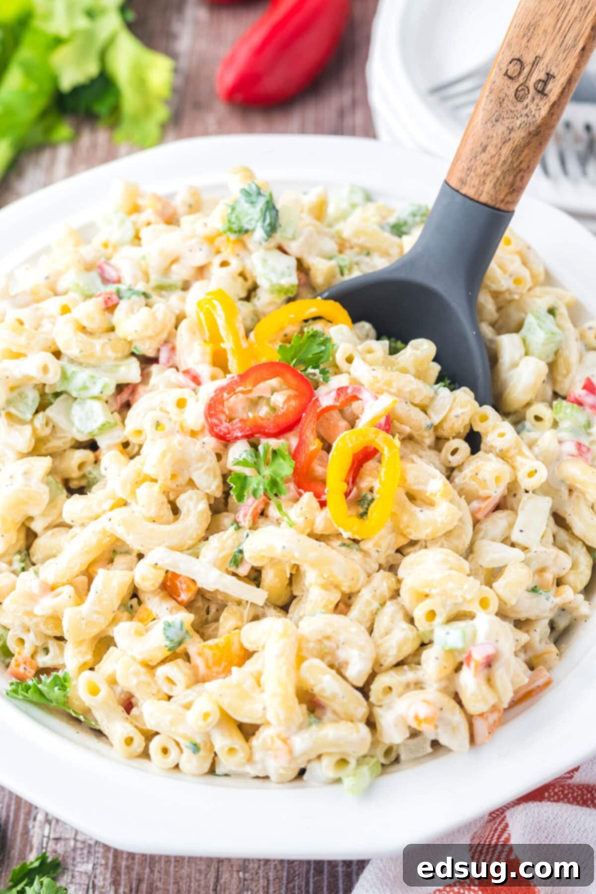 Creamy Macaroni Delight 2 a serving spoon in a bowl of macaroni salad