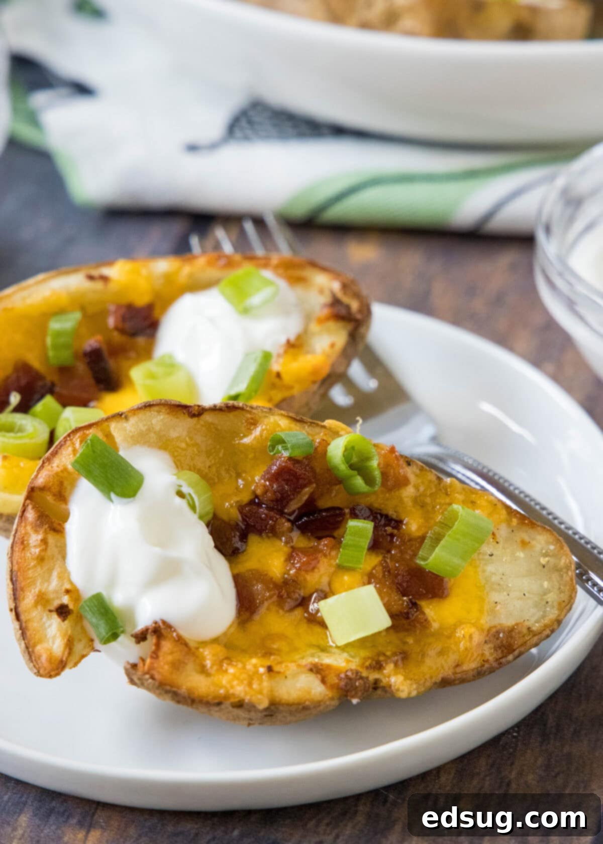 potato skins on a plate with a fork