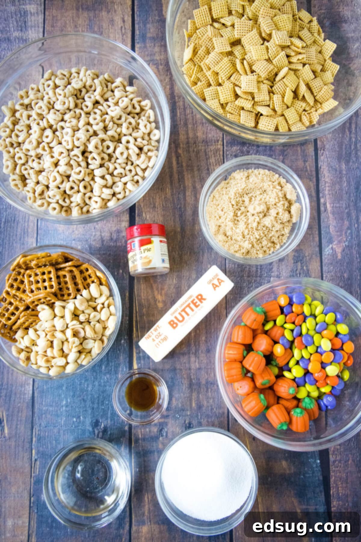 Cozy Pumpkin Spice Crunch 3 All the essential ingredients for making pumpkin spice snack mix laid out on a surface, ready for preparation.