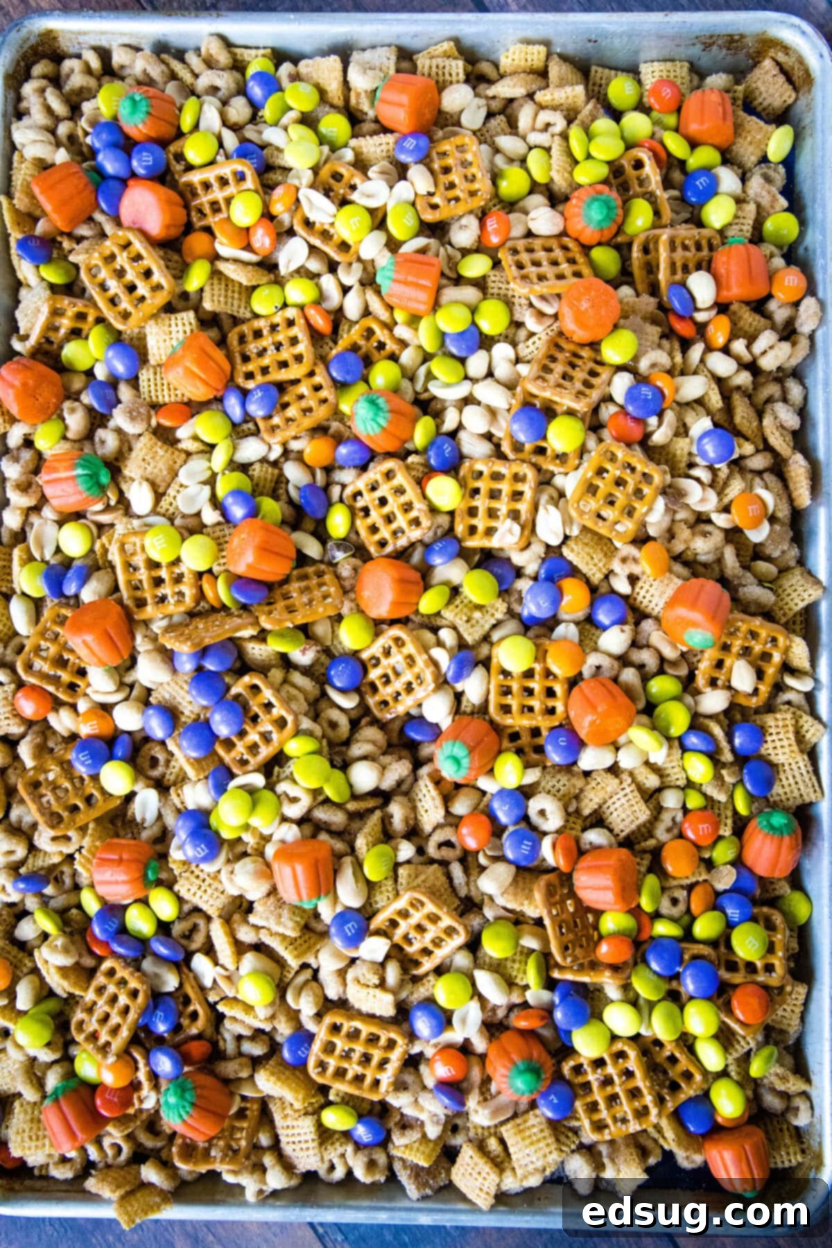 Cozy Pumpkin Spice Crunch 5 Close-up of baked pumpkin spice snack mix on a baking sheet, showing its golden-brown, crispy coating.