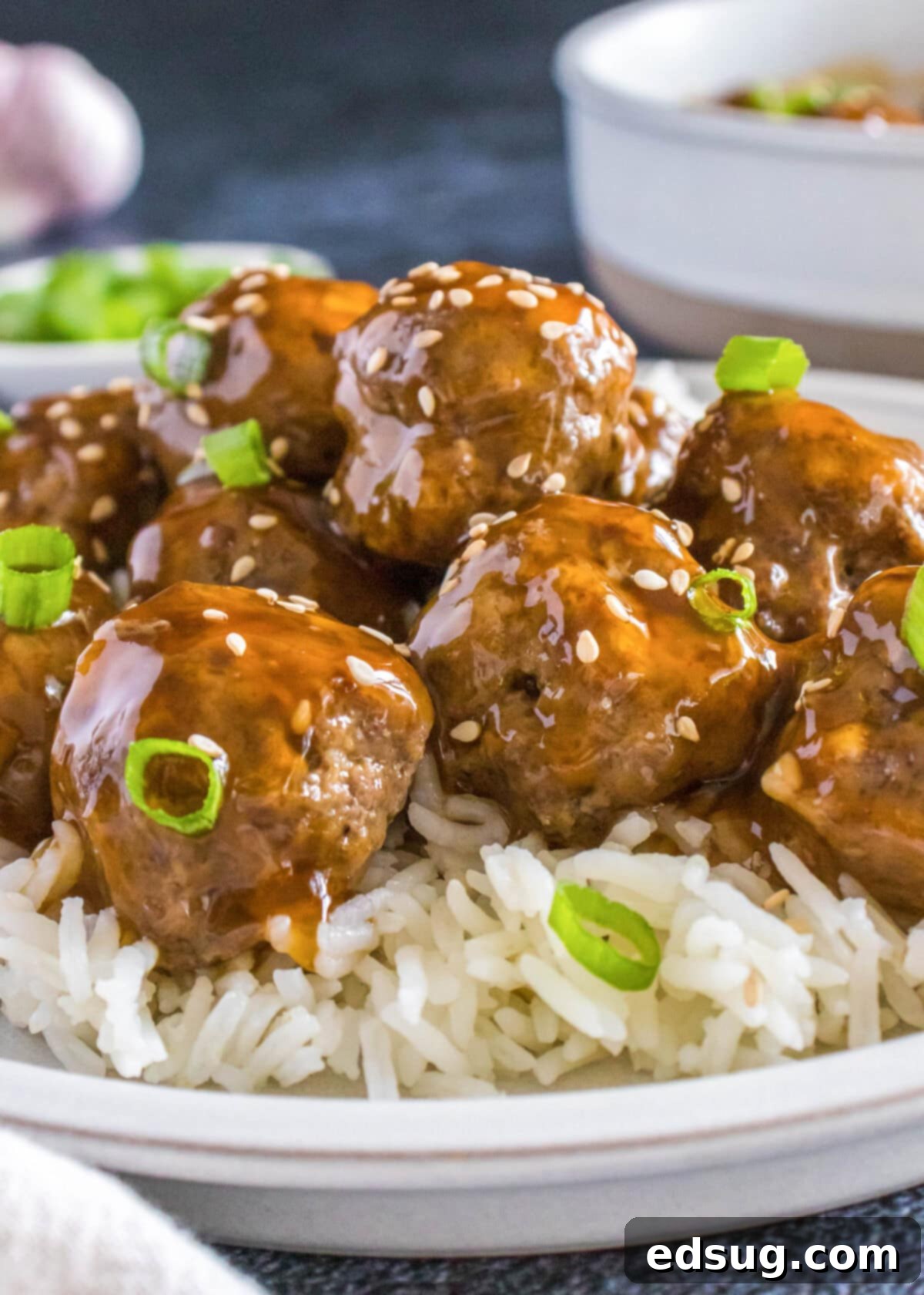 korean meatballs over white rice on a plate