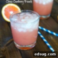 Citrus Cranberry Punch in a glass, ready to serve with a garnish