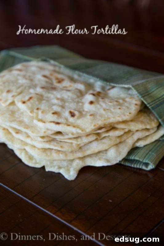 Soft Homemade Flour Tortillas 2 Homemade Flour Tortillas cooked until golden brown and stacked in a towel, ready to serve.