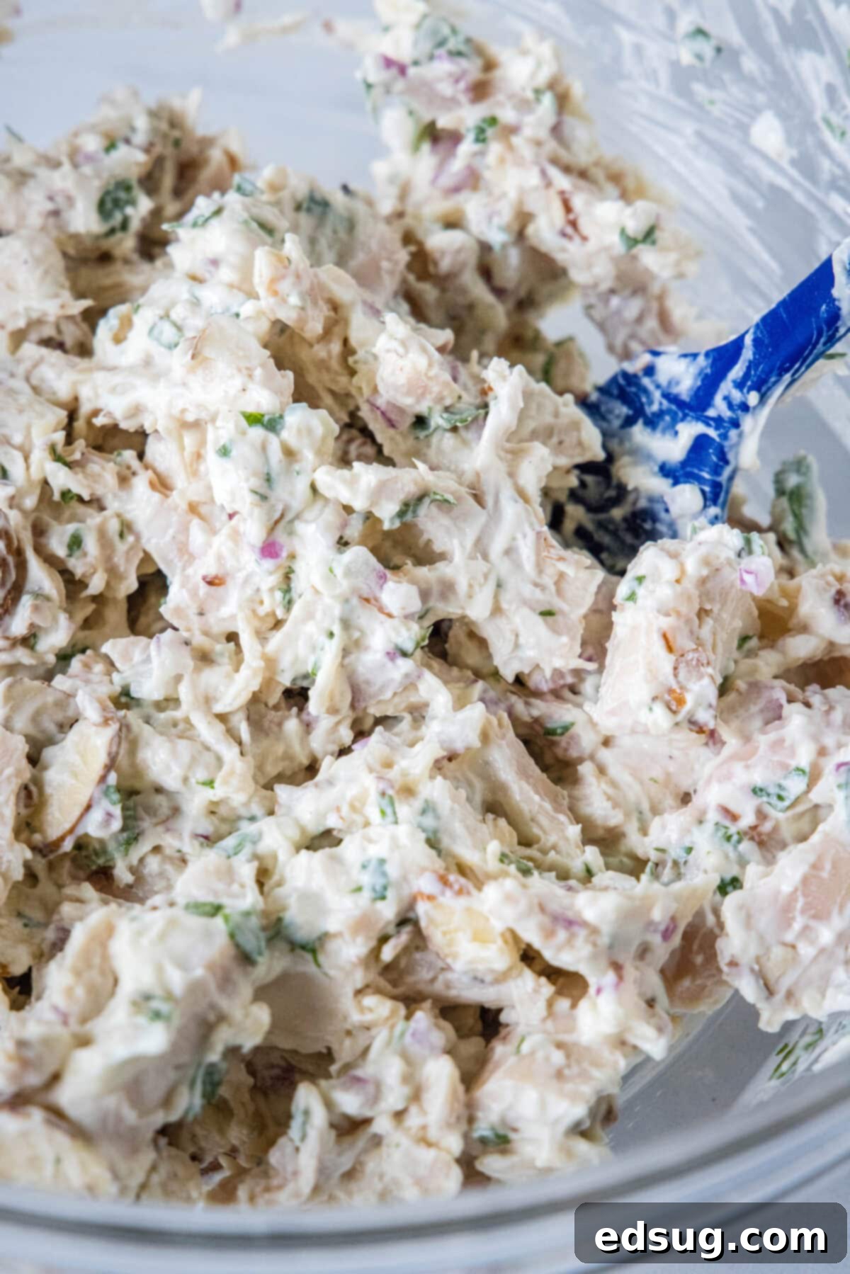 Creamy Greek yogurt chicken salad mixed together in a large bowl, showing its ready-to-serve texture.