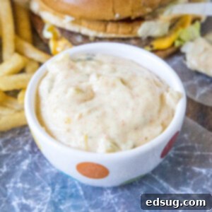Big Mac Sauce in a small serving bowl, with a burger and fries in the background.