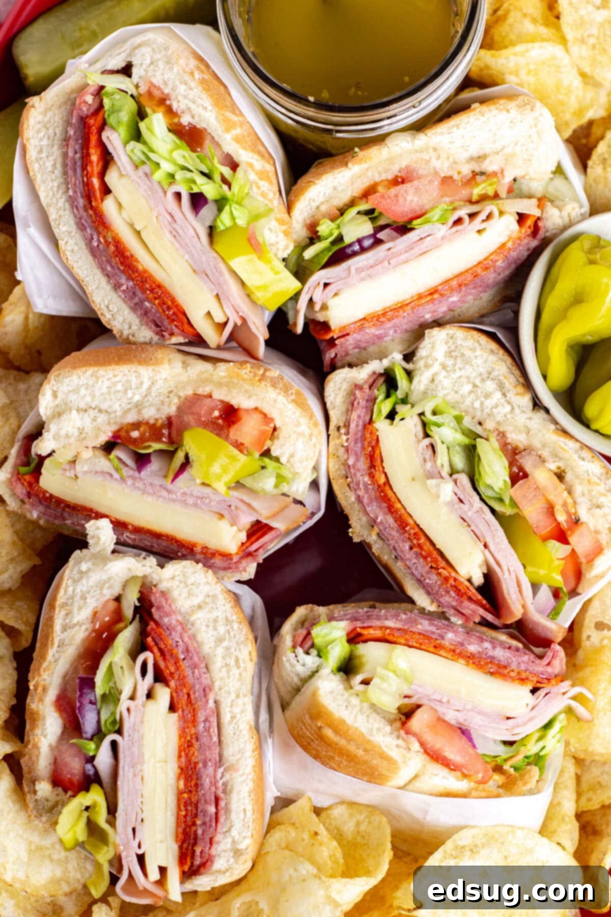 Italian Hoagies 2 looking down on italian subs and potato chips on a platter