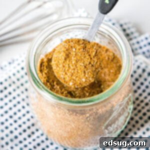 Cajun Blackening Blend 6 close up teaspoon of seasoning above a spice jar