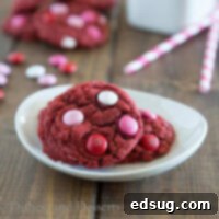 Rich Red Velvet M&M Cookies 2 red velvet m&m cookies on a plate