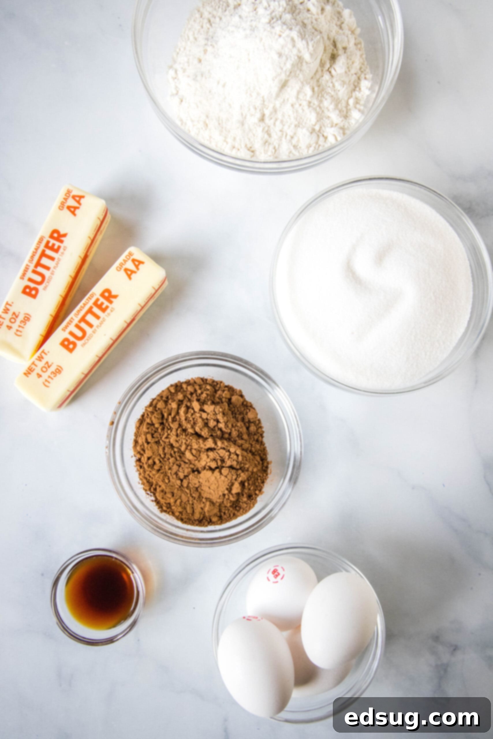 Lunch lady brownies are moist, fudgy brownies just like the ones served at school lunches! Every bite is filled with chocolate flavor. A flat lay photograph showing all the fresh ingredients needed for making lunch lady brownies on a white surface.