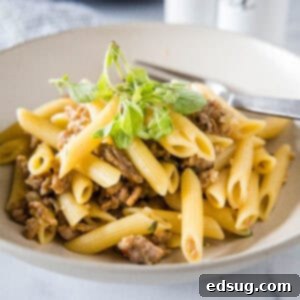 Pasta Risotto Reimagined 2 Pasta risotto garnished with oregano leaves in a white bowl with a fork.