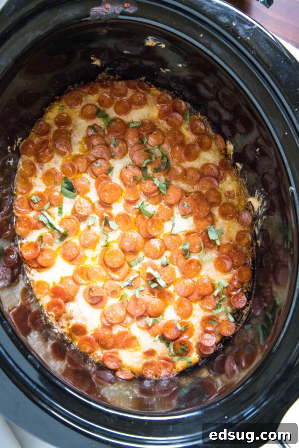 Cooked Crock Pot Pizza Dip in a slow cooker, ready to be served
