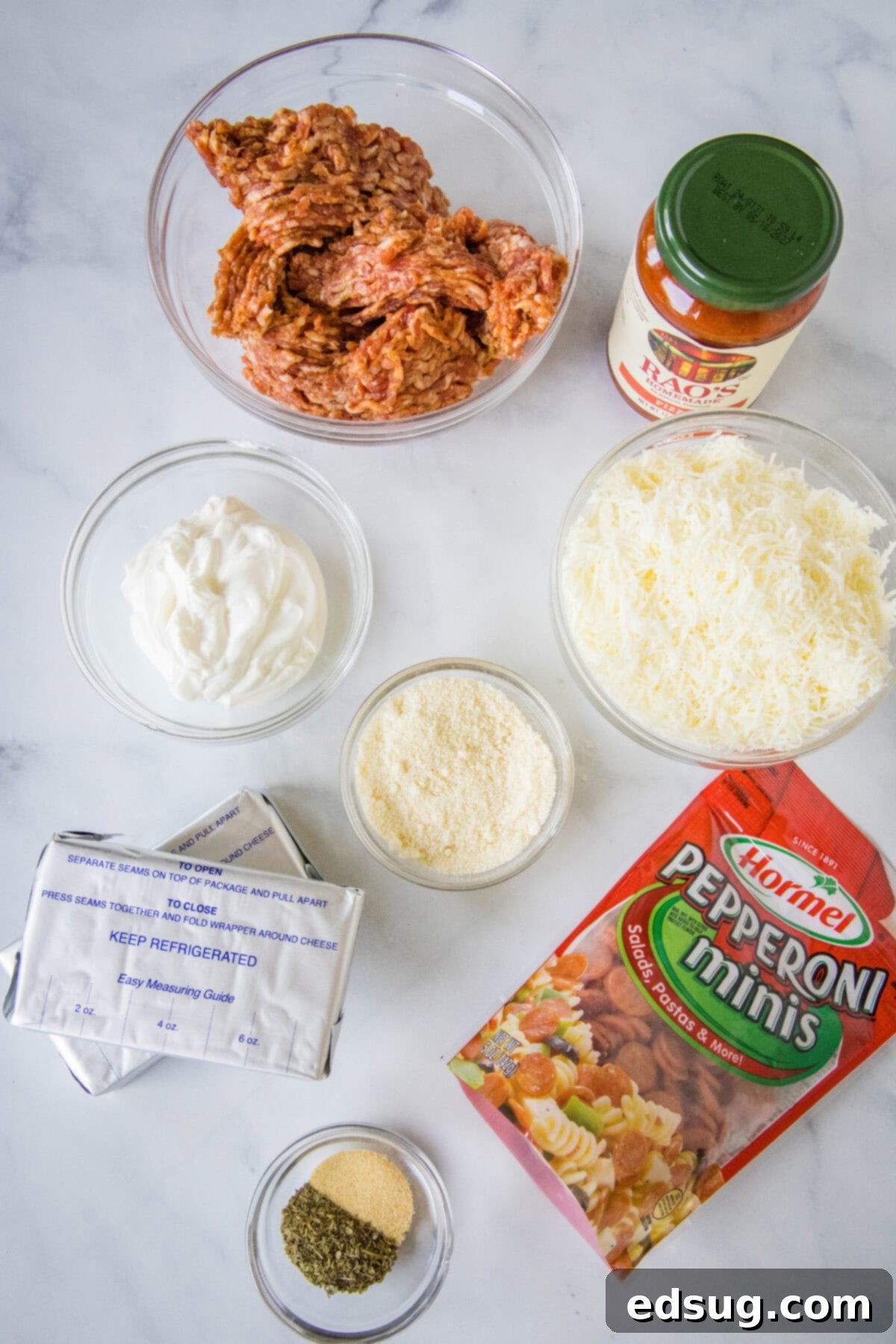 Ingredients laid out for Crock Pot Pizza Dip, including cheeses, sauce, and pepperoni