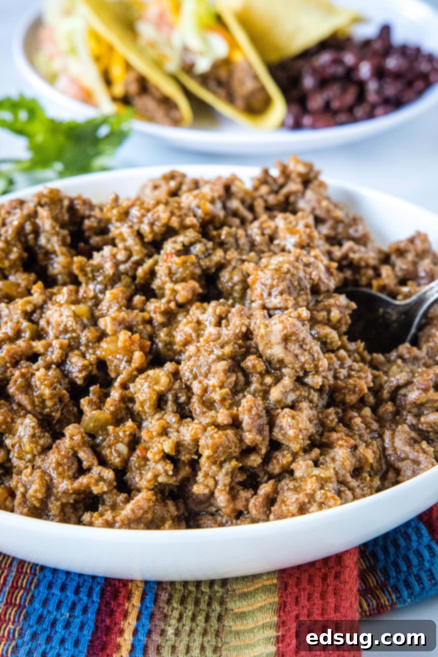 This slow cooker taco meat is an easy, 3-ingredient crock pot recipe that's packed with flavor. Perfect for parties and busy weeknights! Slow cooker taco meat in a large white bowl, ready to be served.